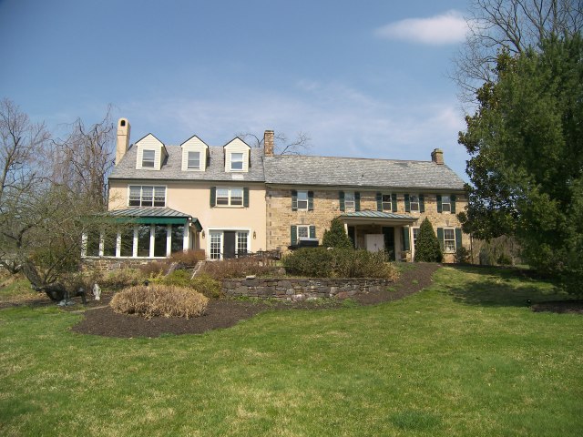My room is the lovely sunroom seen at the left in this photograph.  In addition to the interior renovations, the gardens will be transformed during the designer house as well.
