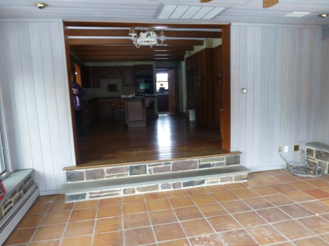 The kitchen features dark cabinets and will be updated beautifully by another design firm.  The walls and ceilings in my sunroom space are stained a lovely light gray.