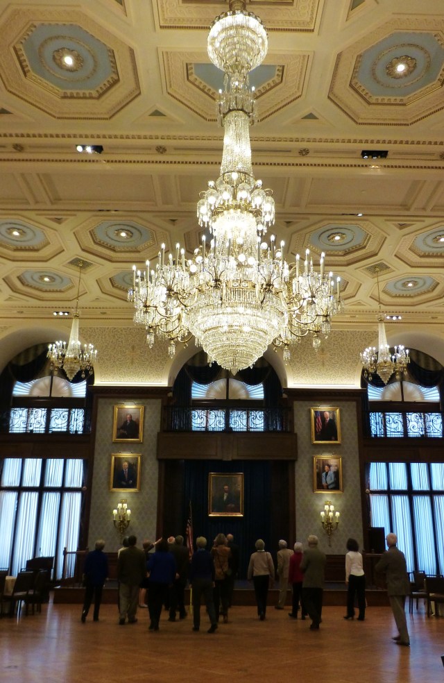 The monumental chandelier in this room almost distracts from the paintings of past club presidents that hang nearly to the ceiling.