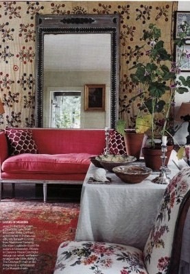 A colorful pink sofa with a large mirror used behind it is very similar to the statement pieces in my Bucks County Designer House sunroom.  
