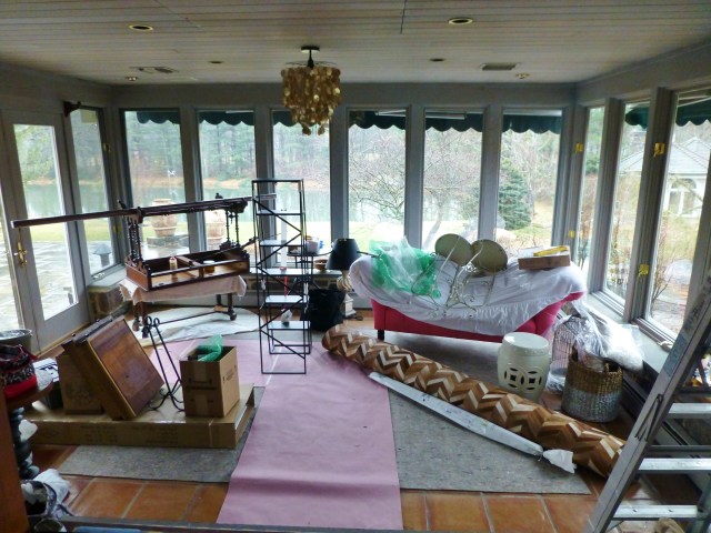 A jumble of furniture, rugs, and accessories as the room starts to take shape.  Can you see the capiz chandelier in place where the ceiling fan used to be?  And my beautiful chevron patterned cowhide rug rolled up on the floor?