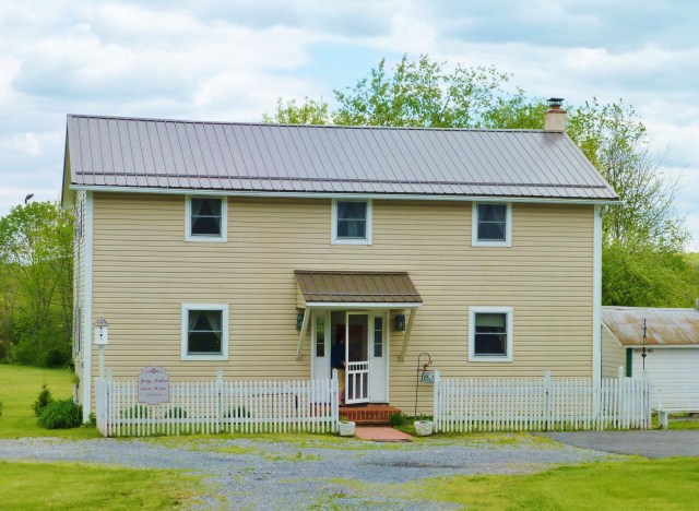 The modest guest house where we stayed is clean and decorated with quaint early-American reproductions.  It has 3 bedrooms, 2 bathrooms, a kitchen, and laundry, plus an ample living area, dining room, and a wonderful screened porch...everything you need for a relaxing visit!