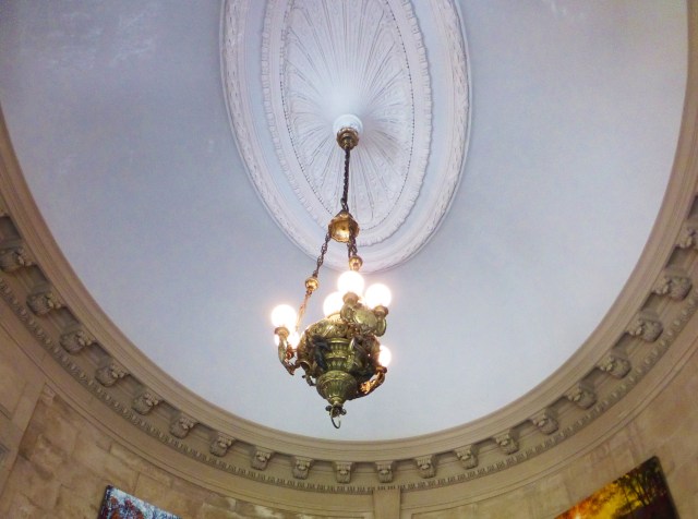 The oval ceiling medallion highlights a charming chandelier original to the home.  In this shot, you can also appreciate the detailed moldings of the stairwell.