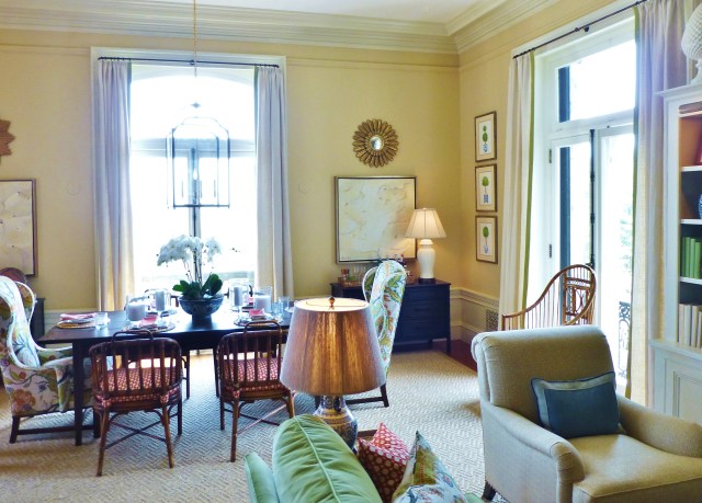 The same vibrant floral fabric is used once again on wingback captain's chairs flanking the casual table.  A set of vintage rattan chairs adds texture and warmth for the remaining seating.