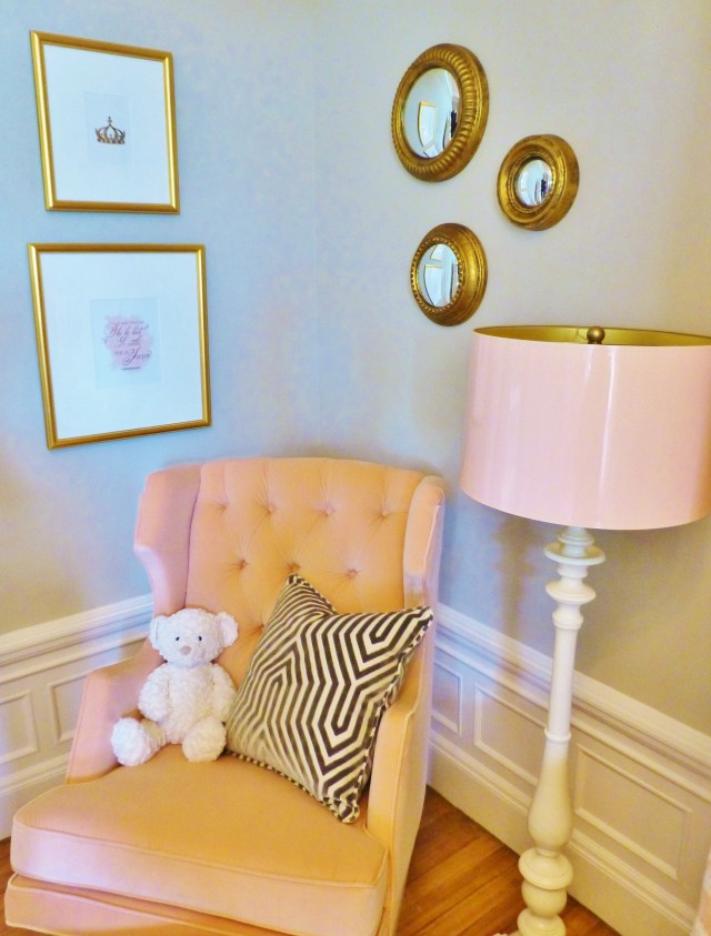 Notice the high-gloss pink lampshade on the floor lamp and the very cool artwork and circular mirror grouping.  I also especially like the geometric fabric on the custom pillow...definitely not your average, run-of-the-mill baby's room!