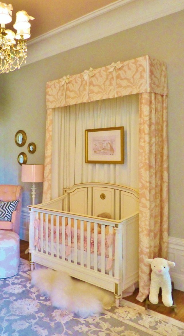 A detail of the stunning canopy surrounding the precious white crib.  The artwork hung inside the canopy is the designer's rendering of this stunning nursery.