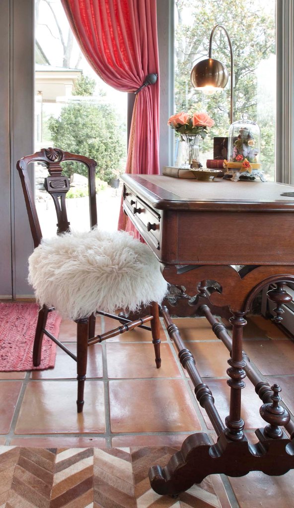 Here's a detail view of the desk, and the adorable Victorian chair with its flokati wool covered seat.  I also love the modern lamp and the Victorian style cloche on the desk.