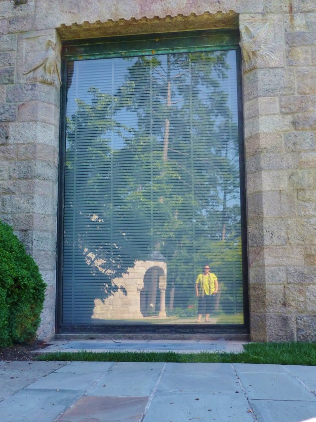 A 'selfie' I took of my reflection in one of the massive first story windows at Glencairn. Notice the stone relief carvings of birds at the top corners of the window and another view of the beautiful pavilion reflected behind me.