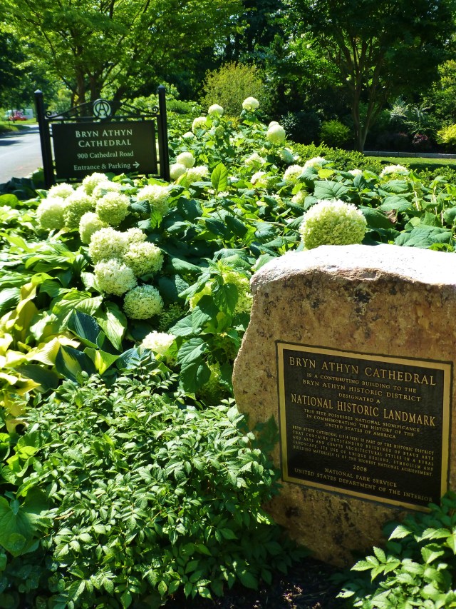 This stone is positioned amongst lovely plantings at the entrance to the Bryn Athyn Cathedral.  The bronze plaque commemorates the prestigious National Historic Site designation.