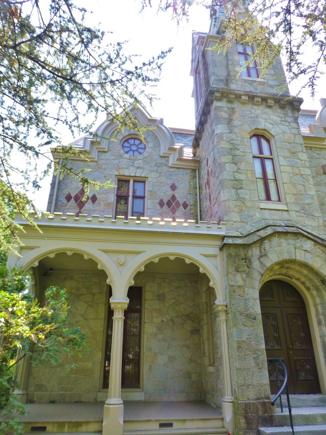The front porch is a modest size, located adjacent to the lovely arched front door.  I can just picture the Victorian family lounging in some wicker chairs on a summer afternoon.