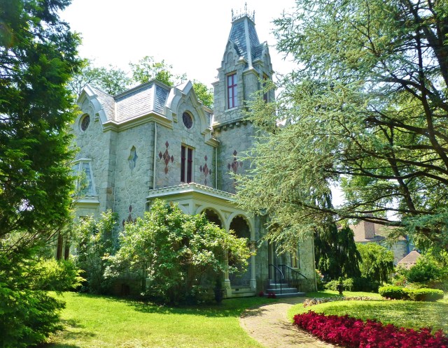 The masonry and stone building is two-and-a-half stories, and has a three-story tower at the front. The roof is in the mansard style, with slate covering. The house has three lovely porches and four stone chimneys.