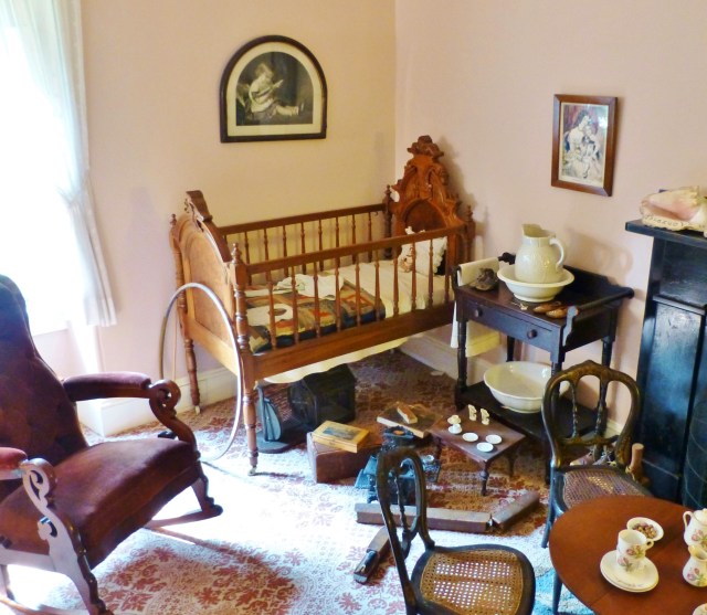 In the corner is a Renaissance Revival style crib with a wash stand next to it.  Remember there was no running water in most houses at this time. 