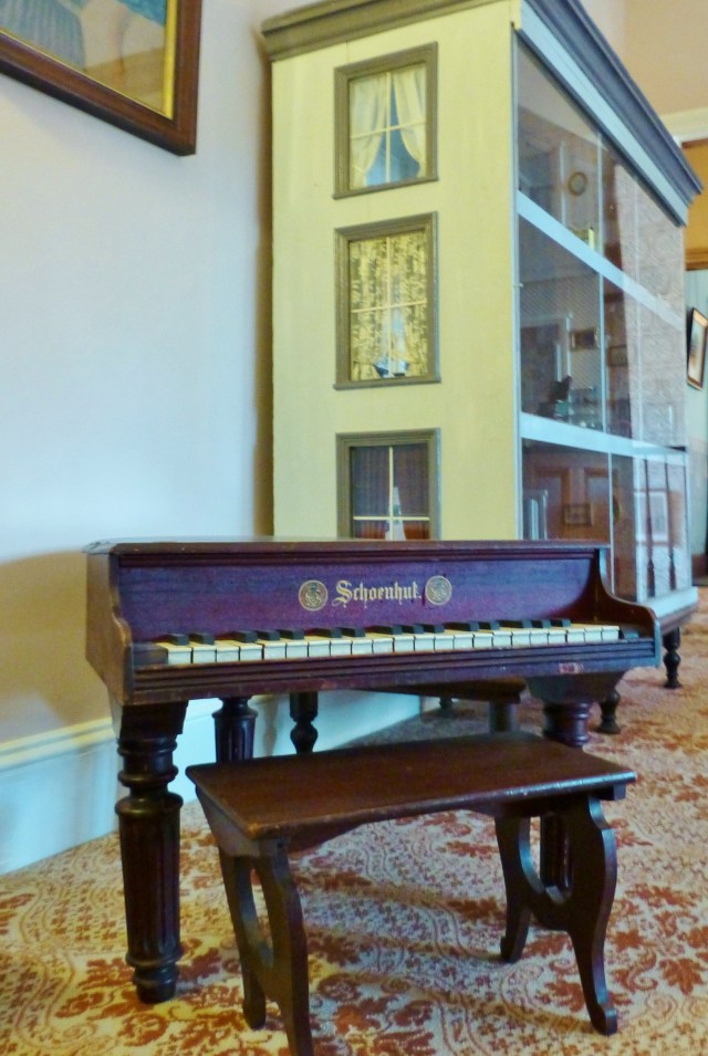 On our way out of the room is this lovely child-sized Schoenhut baby grand piano.  Did you know there are groups of people who write and record music specifically for these tiny pianos?  The children in this household were very fortunate...let's check out that humongous dollhouse next!