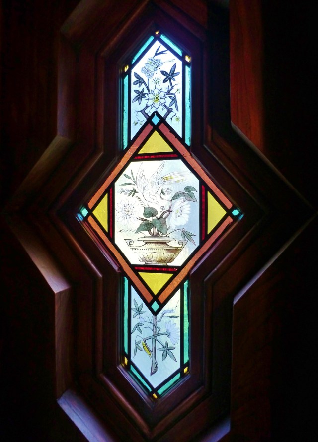 I managed to get a close-up of the phenomenal hand painted stained glass window (there's another one in the lounge).  The shape and color of these is truly stunning!  They feature botanicals with birds and insects.