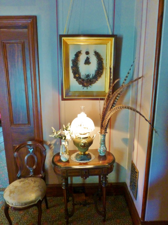 The corner to the left of the bed houses a charming little table and chair.  My favorite thing hangs above the table...