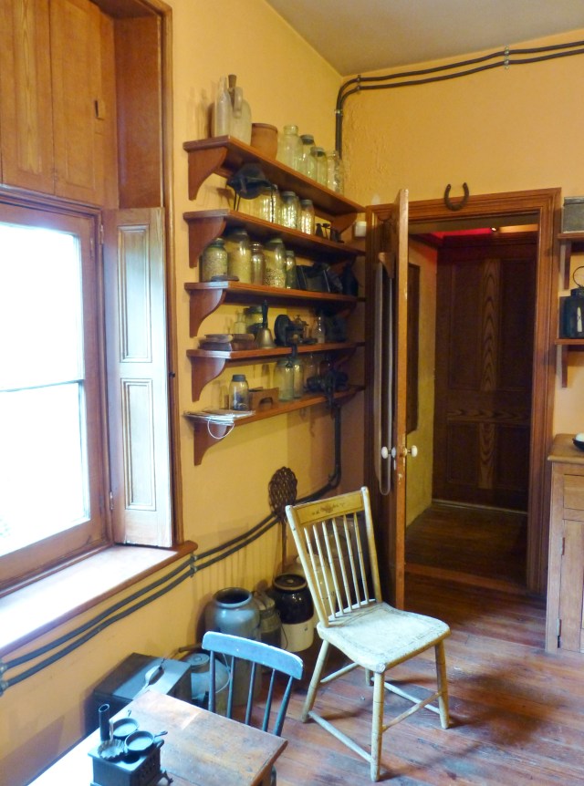 Notice the tubes attached along the ceiling and down below the window.  These are the hot water lines, leading from the water tank (with water heated by the iron stove) and over to the sink.  