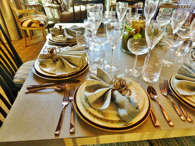 The tables are set beautifully with a formal gilded place setting and a mix of lovely crystal glasses.