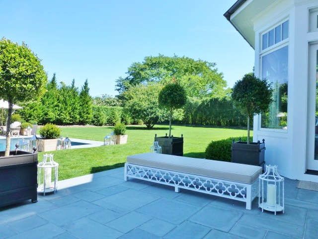 There are doors in the kitchen, leading to the stately bluestone terrace" width="640" There are doors in the kitchen, leading to the stately bluestone terrace.  Ample seating, combined with useful lanterns and gorgeous tall topiaries enhance this useful extension of the home.