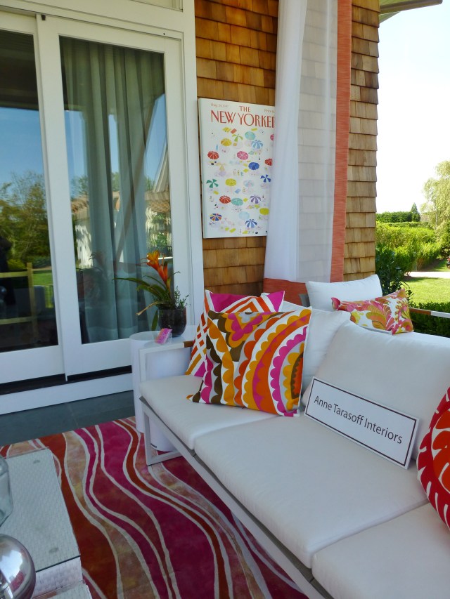 The designers, Gail and Karyn, used bold colorful accessories with crisp white outdoor furniture for this comfy sitting room.