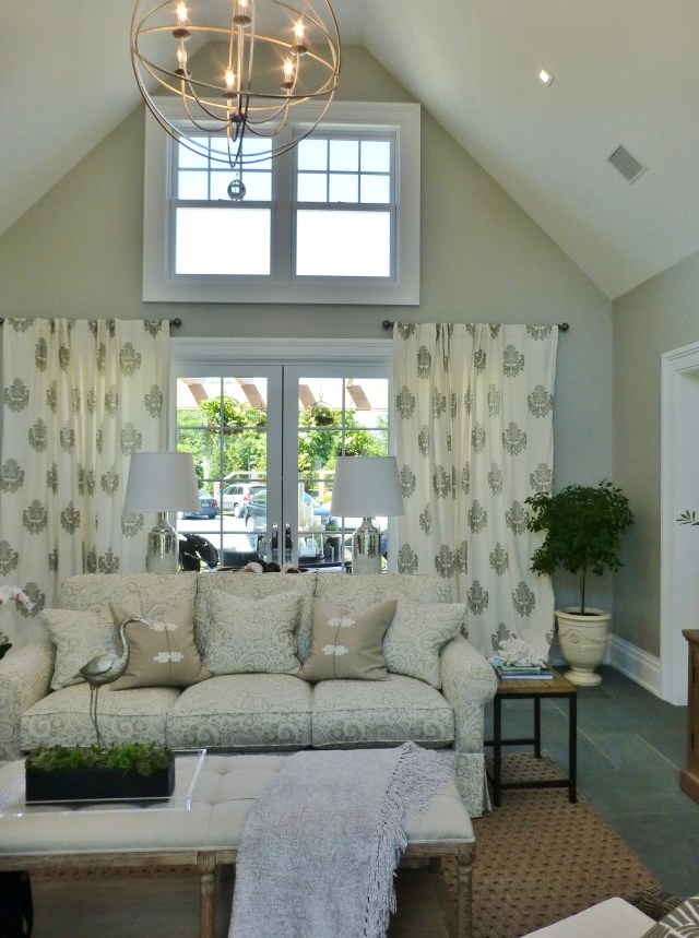 The main living area is very neutral with bluestone floors and warm gray walls.  The vaulted ceiling helps make the space feel a bit larger, as does the limited color palette.  