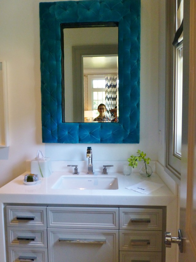 The bathroom mirror was wonderful!  It has a teal tufted velvet frame, which softens all the hard surfaces in this space.  The reflection shows the chevron draperies in the library, and my wonderful son, Grady too!  We have such fun touring these properties together. 