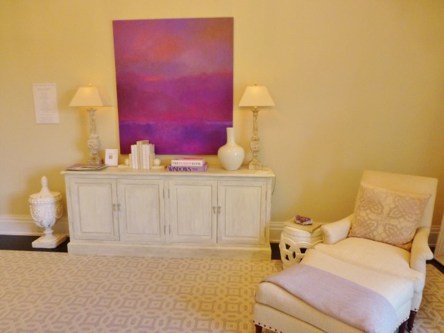 Directly across from the bed is this painted dresser with bold modern art hung above. A comfy chair and ottoman reside in the corner.