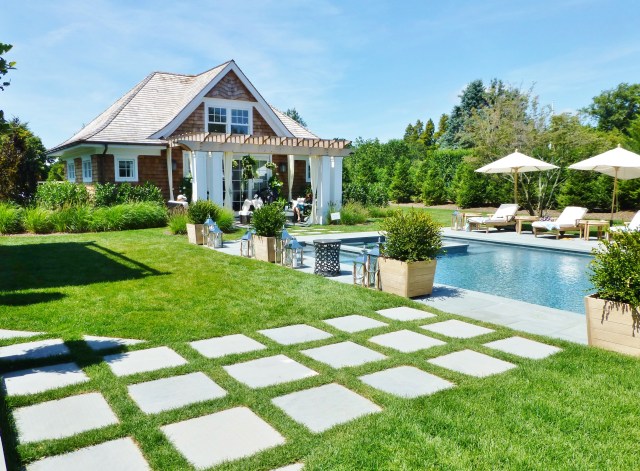 The adorable pool house and guest cottage has an elegant terrace all its own.