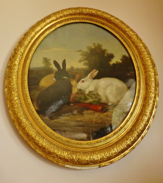 Dogs were by no means the only treasured companion in this family, as this portrait of two bunnies shows.