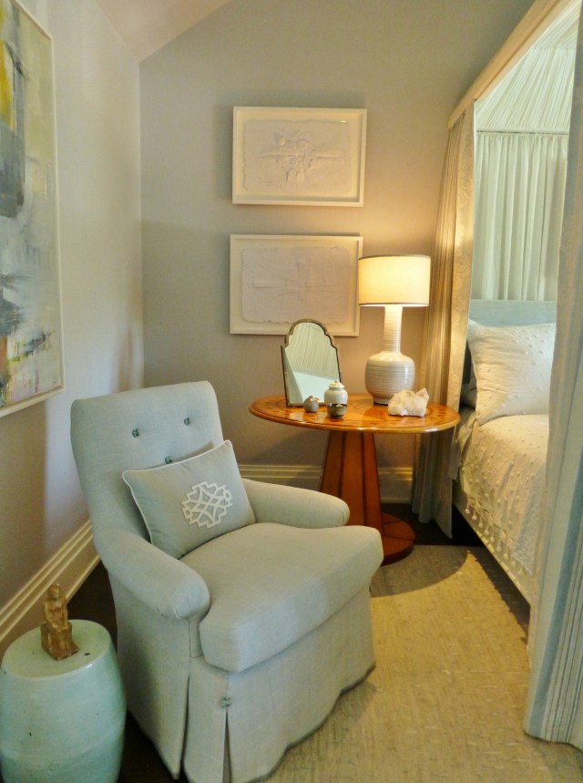 To the left of the bed, and just inside the door is a tailored, yet comfy chair, covered in soft blue linen with kick pleats on the waterfall skirt.   The pillow features a white geometric applique.   And I'm sure you've already noticed that terrific garden stool/drinks table beside the chair--I just love those!