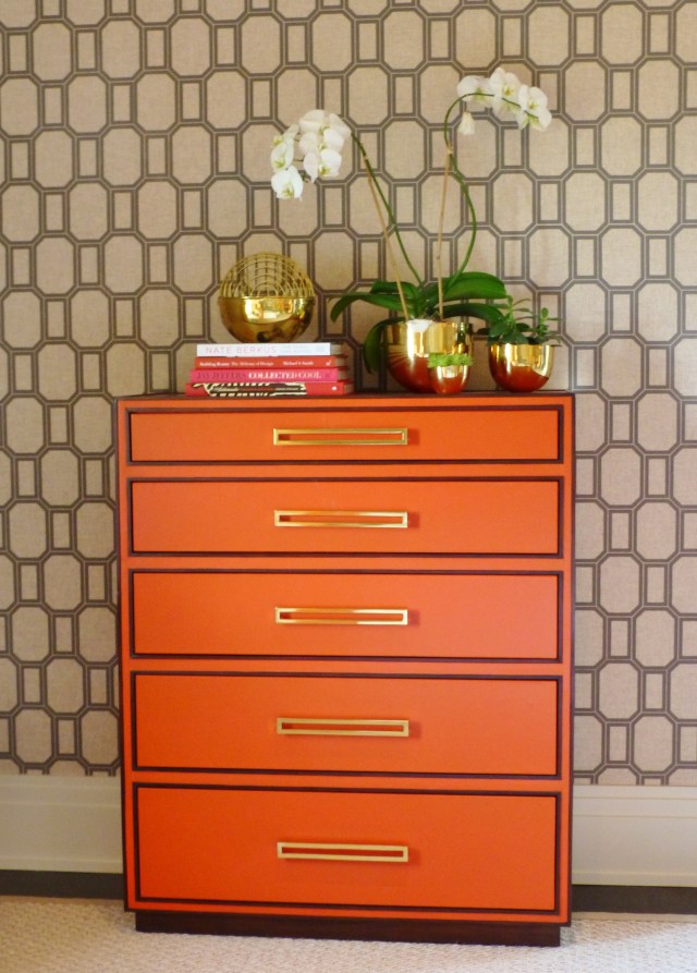On the opposite side of the bed is this stunning orange chest of drawers.  The color brings to mind the iconic Hermes branding. And don't you just love the wide brass drawer pulls?  The look amazing with the brass accessories atop the bureau, which have a funky 1970's vibe.