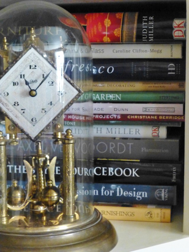 This glass-domed anniversary clock resides in front of my vast collection of interior design books.