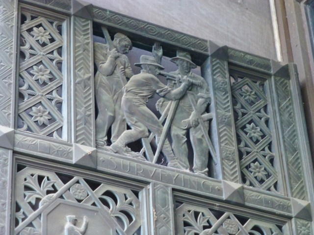 A detail of the surveying panel on one of the bronze doors at the Pennsylvania State Capitol Building in Harrisburg.