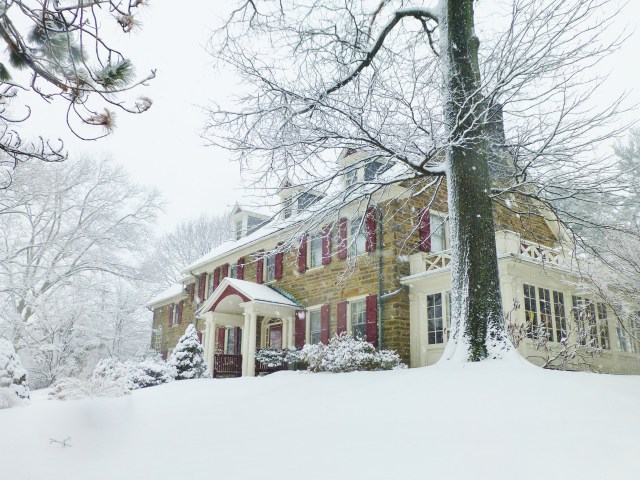 Another gorgeous stone house, this time with rusty red shutters and matching benches on the front porch.  