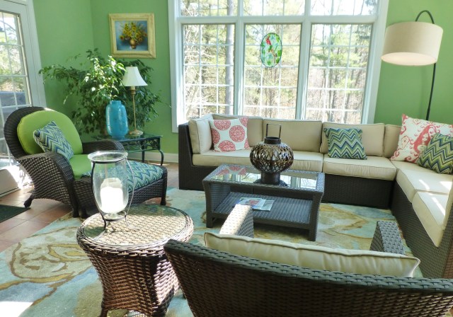 AFTER:  the large sectional with neutral cushions anchors the space and breaks up all the bold color.  Scale is so important in a large room like this one. A large, contemporary wool area rug anchors the seating area and adds to the color story. 