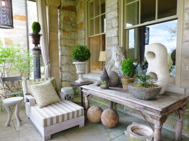Barry Dixon's back porch contains an amazing variety of garden statuary, accessories and many examples of his own furniture line.  It must be so wonderful to lounge out here, taking in the view of the grounds at Elway Hall in the summertime!