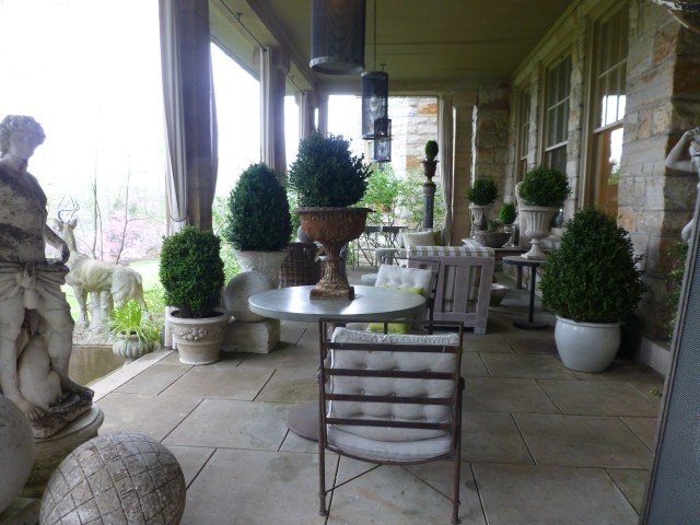 Looking across the wide terrace, you can see the many distinct groupings and seating areas.  All the furnishings were kept neutral and stone-colored, and plantings are mostly boxwood in large stone planters.