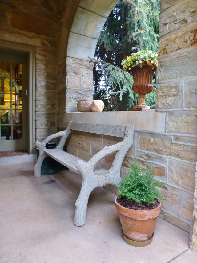My final image is from a little side porch off the front of Elway Hall.  I thought the stone faux bois bench was so charming centered under the archway.  And the giant nut sculpture sitting up on the ledge is fantastic too!