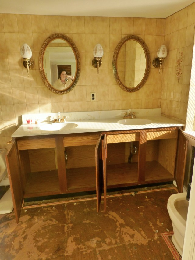 Upon entering the bathroom, visitors are confronted with this wide, double-vanity. The homeowner is planning to have this vanity base painted, and new countertops, sinks, and fittings will be installed. The vanity mirrors will remain, albeit with a new finish as well. All the wall tiles will be demolished and new floors will be installed.